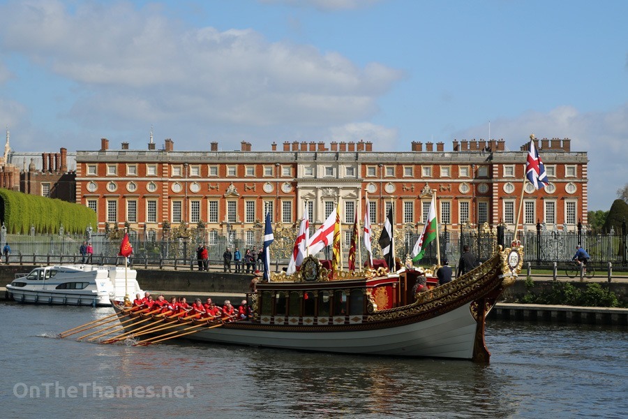 © Licensed to London News Pictures. 18/04/2014. The Queen's Row Barge Gloriana on the Thames at Hampton Court in Good Friday's glorious sunshine. It was the first engagement of 2014 for the popular row barge and she was rowed to Hampton Court Palace with "King George I" on board for the palace's Glorious Georges season . Credit : Rob Powell/LNP