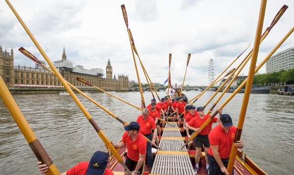 The crew of the Gloriana 'toss oars' as a salute to the Palace of Westminster MV Gloriana rows up the Thames as part of HM The Queen's 90th Birthday celbrations
