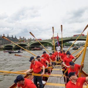 The crew of the Gloriana 'toss oars' as a salute to the Palace of Westminster