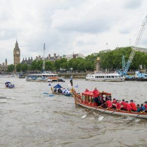 The small boat flotilla behind the Gloriana MV Gloriana rows up the Thames as part of HM The Queen's 90th Birthday celbrations