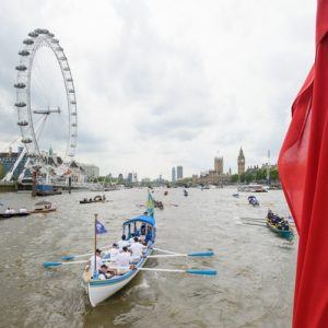 The small boat flotilla behind the Gloriana MV Gloriana rows up the Thames as part of HM The Queen's 90th Birthday celbrations