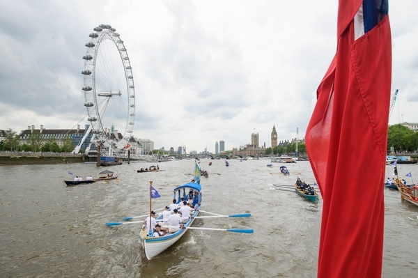 The small boat flotilla behind the Gloriana MV Gloriana rows up the Thames as part of HM The Queen's 90th Birthday celbrations